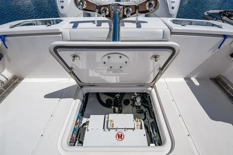Slide: The Image of 2019 Everglades 435 Center Console boat with open hatch revealing engine compartment. - 14