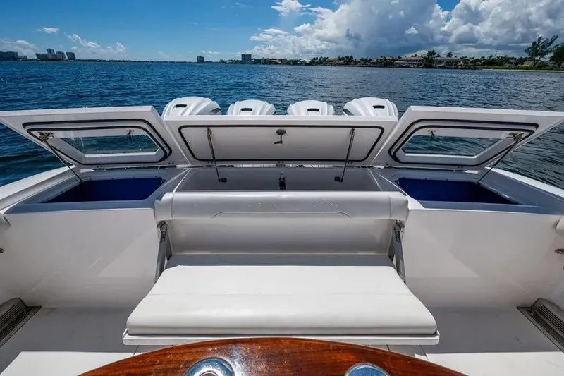 Slide: The Image of 2019 Everglades 435 Center Console boat with open storage compartments on a sunny day. - 17