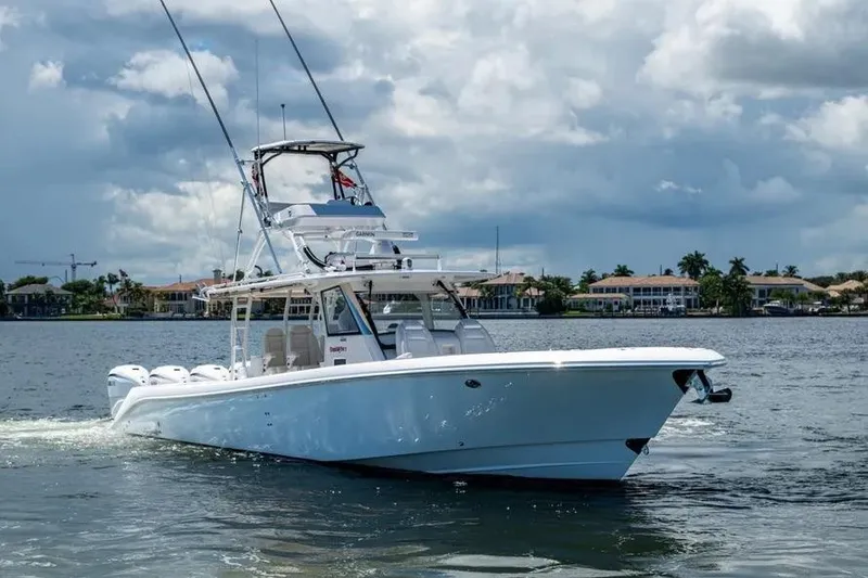 Slide: The Image of 2019 Everglades 435 Center Console boat cruising on a scenic waterway. - 3