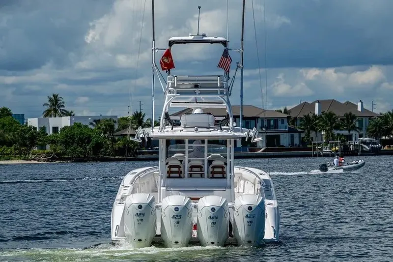 Slide: The Image of 2019 Everglades 435 Center Console boat with four engines on a scenic waterway. - 5