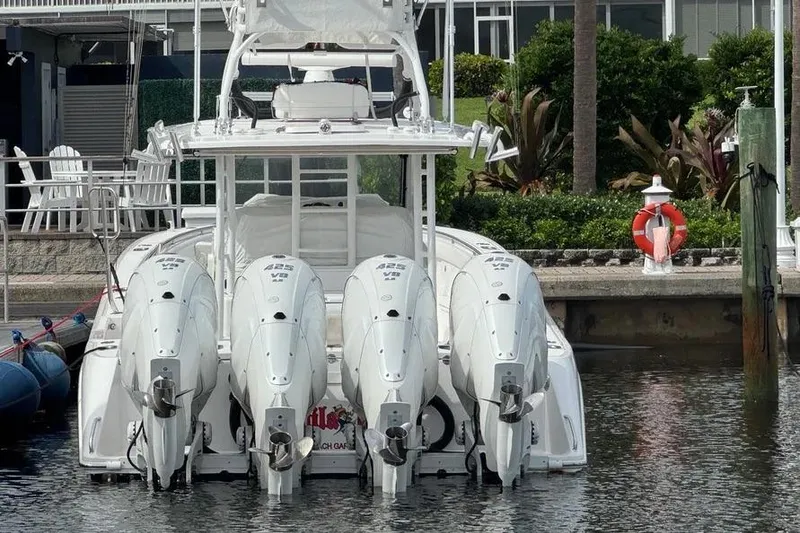 Slide: The Image of 2019 Everglades 435 Center Console boat with four powerful outboard engines docked. - 6