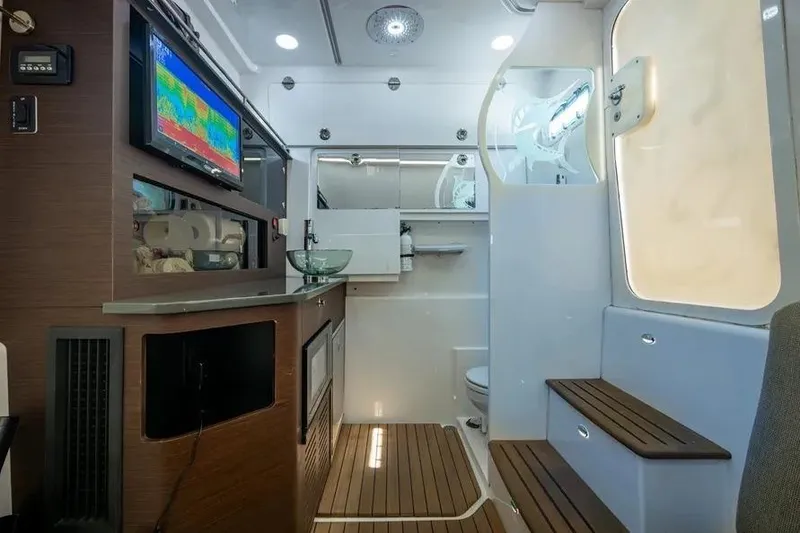 Slide: The Image of Interior of 2019 Everglades 435 Center Console boat with modern amenities and wood accents. - 7