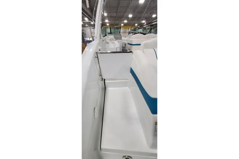 Slide: The Image of 2009 Formula 310 Bowrider interior with white and blue seating in a showroom. - 10