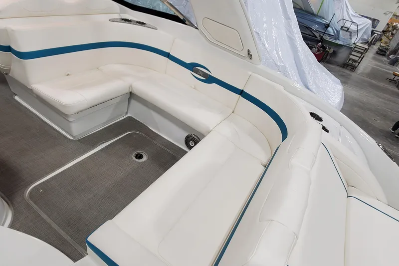 Slide: The Image of 2009 Formula 310 Bowrider interior with white and blue seating, spacious layout. - 11