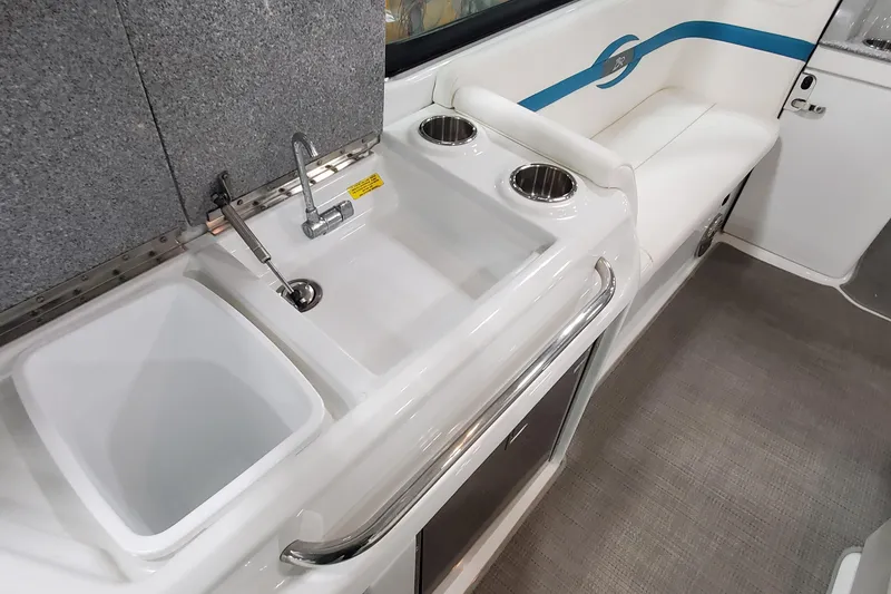 Slide: The Image of 2009 Formula 310 Bowrider interior with sink, faucet, and seating area. - 18