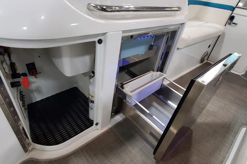 Slide: The Image of 2009 Formula 310 Bowrider interior with open storage compartments and stainless steel drawers. - 19