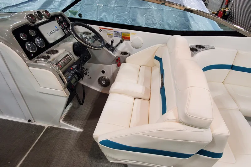 Slide: The Image of 2009 Formula 310 Bowrider interior with Garmin navigation, white seating, and modern dashboard controls. - 21