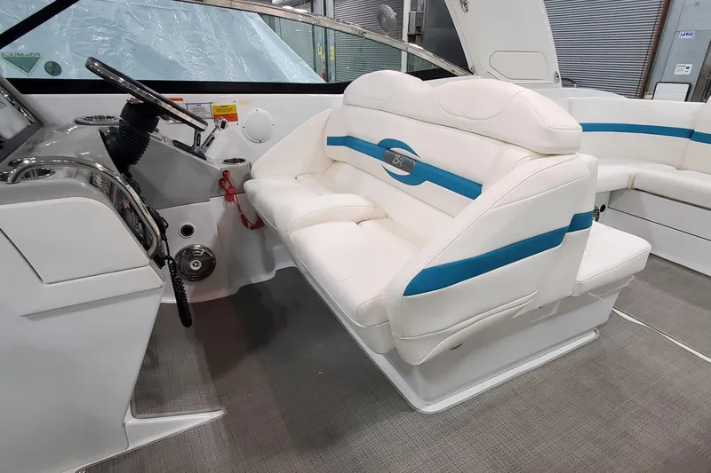 Slide: The Image of 2009 Formula 310 Bowrider interior with white and blue seating, sleek dashboard, and modern design. - 22