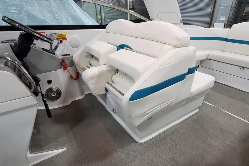 Slide: The Image of 2009 Formula 310 Bowrider interior with white and blue seating, steering wheel, and dashboard. - 23