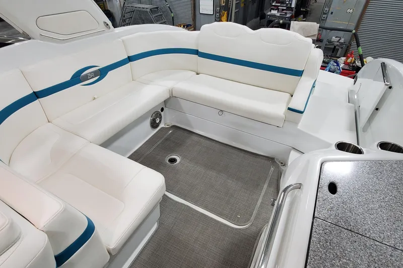 Slide: The Image of 2009 Formula 310 Bowrider interior with white seating and blue accents. - 26