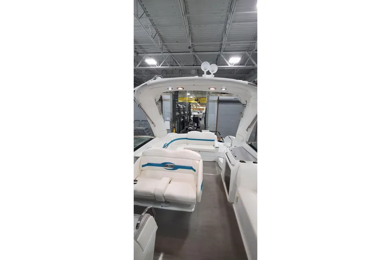 Slide: The Image of 2009 Formula 310 Bowrider interior with white seating in a warehouse setting. - 28