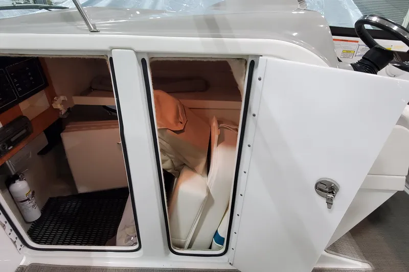 Slide: The Image of 2009 Formula 310 Bowrider cabin interior with storage and seating area. - 31