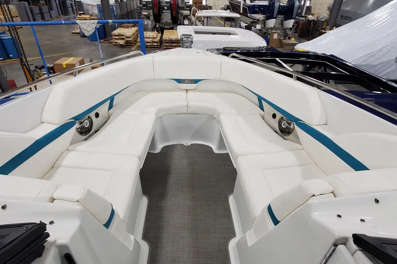 Slide: The Image of 2009 Formula 310 Bowrider interior with white seating and blue accents in a showroom. - 34