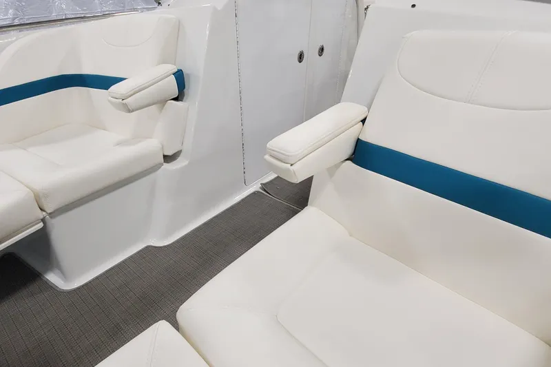 Slide: The Image of 2009 Formula 310 Bowrider interior with white and blue seating, armrests, and carpeted floor. - 35