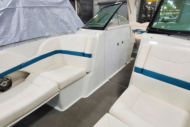 Slide: The Image of 2009 Formula 310 Bowrider interior with white seating and blue accents in a showroom. - 38