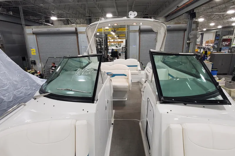 Slide: The Image of 2009 Formula 310 Bowrider in a warehouse, showcasing sleek design and spacious seating. - 39