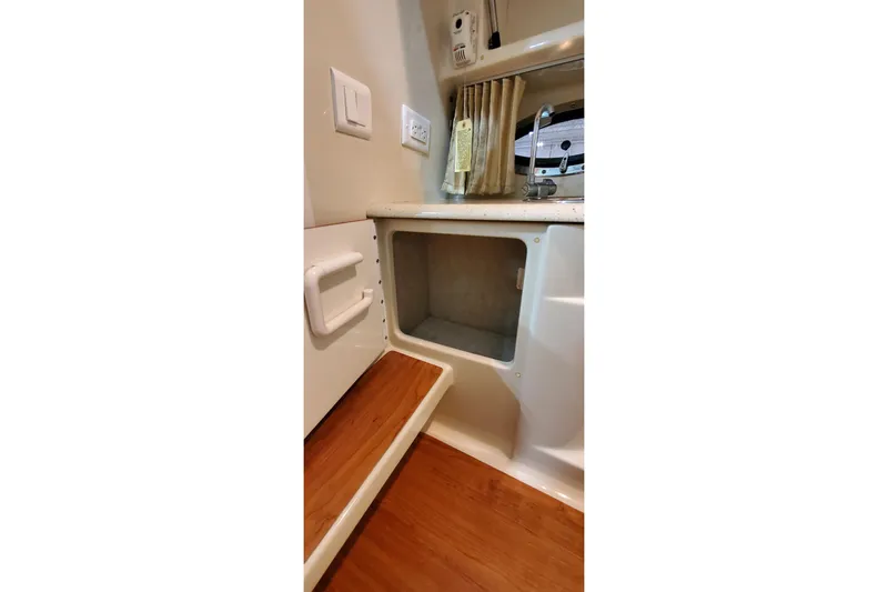 Slide: The Image of Interior of 2009 Formula 310 Bowrider boat with open storage compartment and wooden flooring. - 43