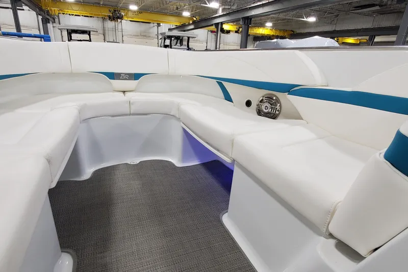 Slide: The Image of 2009 Formula 310 Bowrider interior with white seating and blue accents in a showroom. - 44
