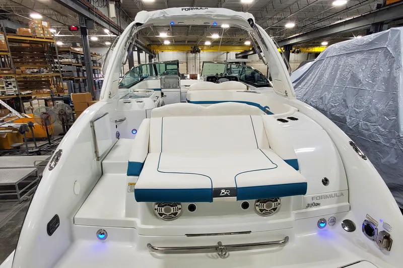 Slide: The Image of 2009 Formula 310 Bowrider boat interior in a warehouse setting. - 46
