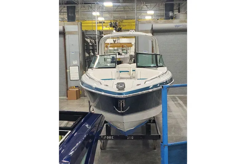 Slide: The Image of 2009 Formula 310 Bowrider boat in a warehouse setting. - 5