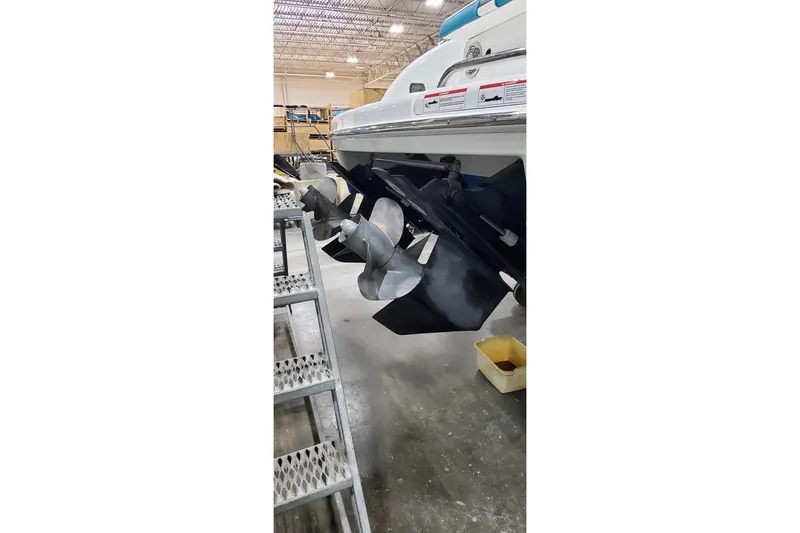 Slide: The Image of 2009 Formula 310 Bowrider boat propellers in a warehouse setting. - 6