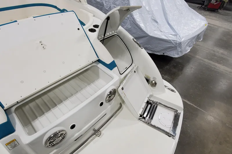 Slide: The Image of 2009 Formula 310 Bowrider boat interior with open storage compartments and speakers. - 8