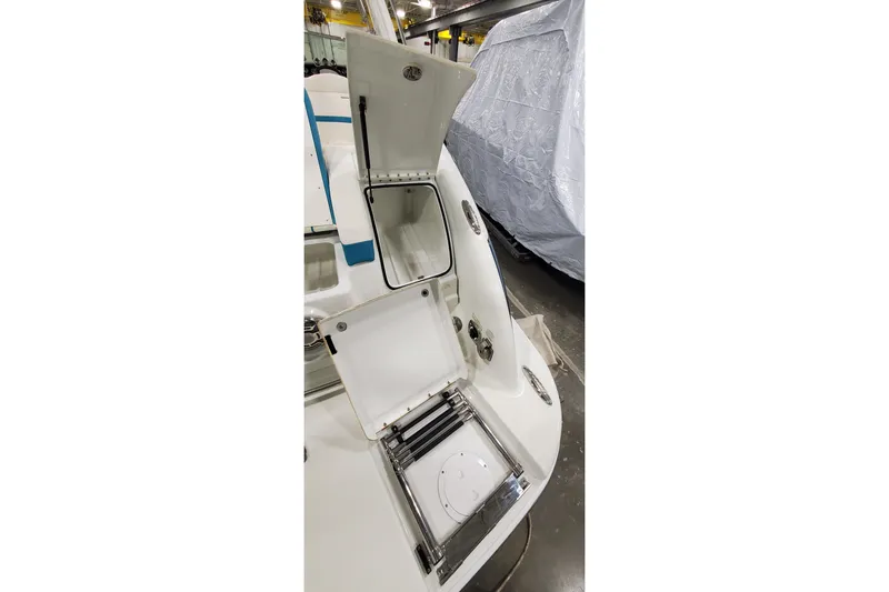 Slide: The Image of 2009 Formula 310 Bowrider boat with open storage compartments in a garage setting. - 9