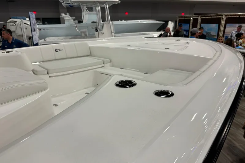 Slide: The Image of 2026 Contender 29 Bay boat interior at a boat show, featuring sleek white seating. - 10