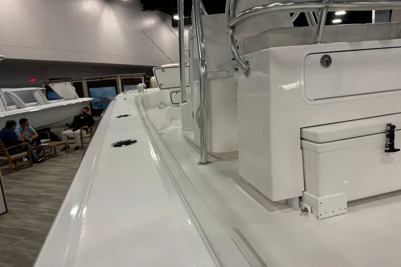 Slide: The Image of 2026 Contender 29 Bay boat interior at a showroom, showcasing sleek design and seating area. - 11