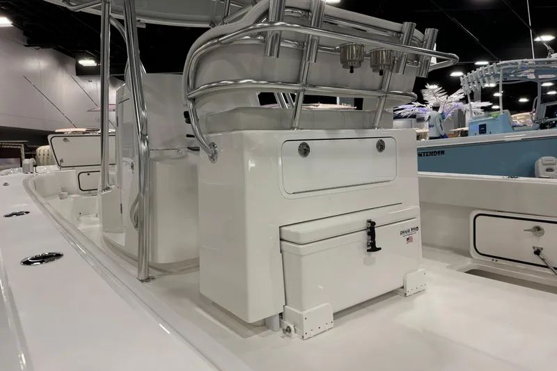 Slide: The Image of 2026 Contender 29 Bay boat interior with seating and storage, showcased indoors. - 12