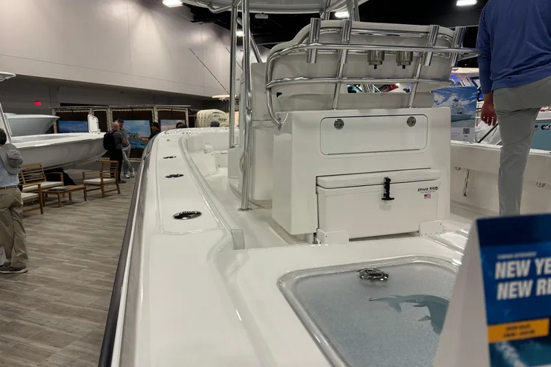 Slide: The Image of 2026 Contender 29 Bay boat displayed at an indoor exhibition, showcasing sleek design and features. - 13