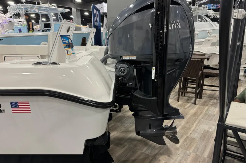 Slide: The Image of 2026 Contender 29 Bay boat with Yamaha outboard motor at a boat show. - 15