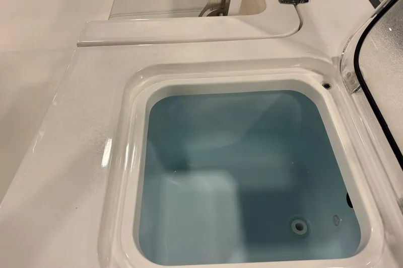 Slide: The Image of 2026 Contender 29 Bay boat livewell with open lid, showcasing interior design. - 17