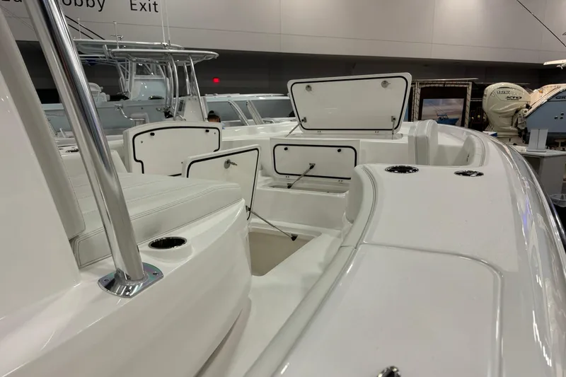Slide: The Image of 2026 Contender 29 Bay boat interior with open storage compartments at a boat show. - 24