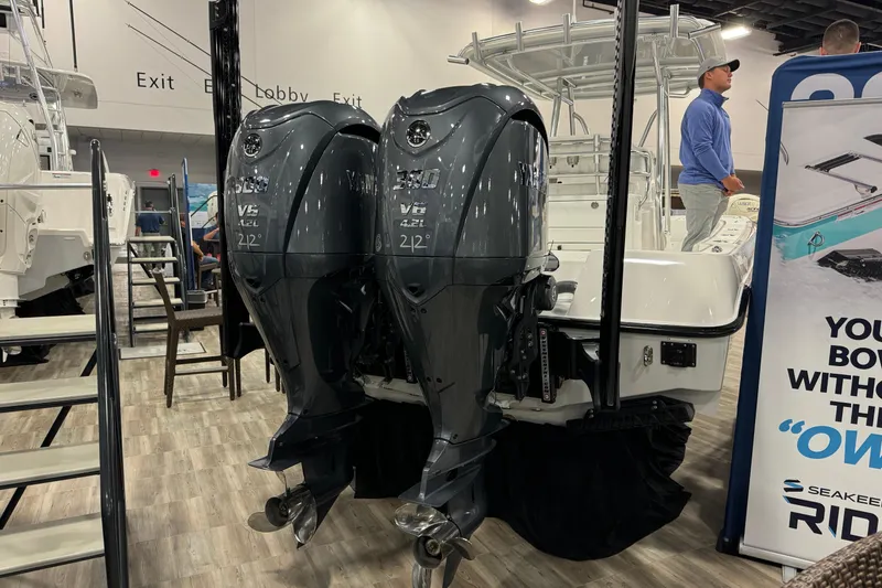 Slide: The Image of 2026 Contender 29 Bay with dual Yamaha V6 outboard engines at a boat show. - 4