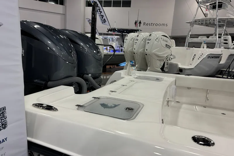 Slide: The Image of 2026 Contender 29 Bay boat with powerful outboard engines displayed indoors. - 5