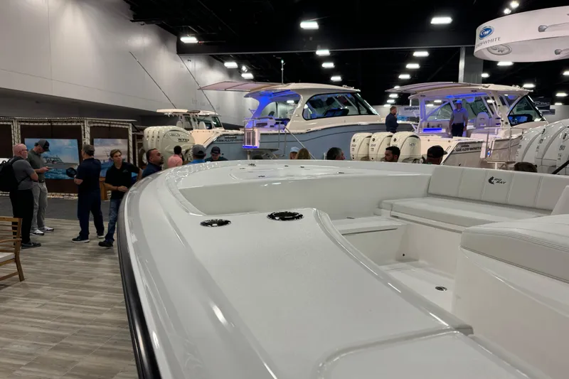 Slide: The Image of 2026 Contender 29 Bay boat showcased at indoor exhibition with attendees. - 6