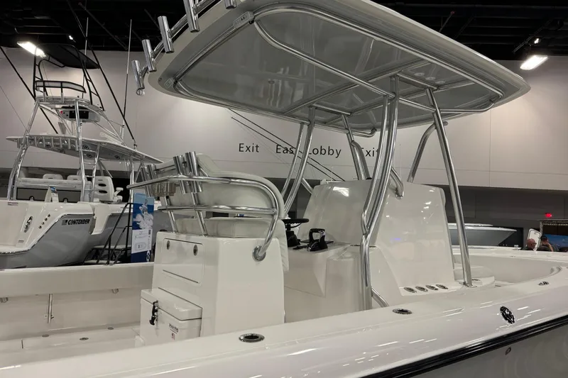 Slide: The Image of 2026 Contender 29 Bay boat with sleek design and modern features at an indoor exhibition. - 8