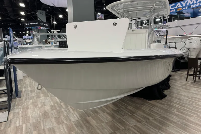 Slide: The Image of 2026 Contender 29 Bay boat displayed at an indoor boat show. - 2