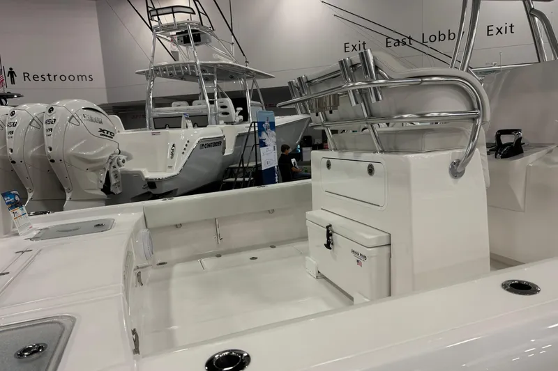 Slide: The Image of 2026 Contender 29 Bay boat interior with dual engines at a showroom display. - 7