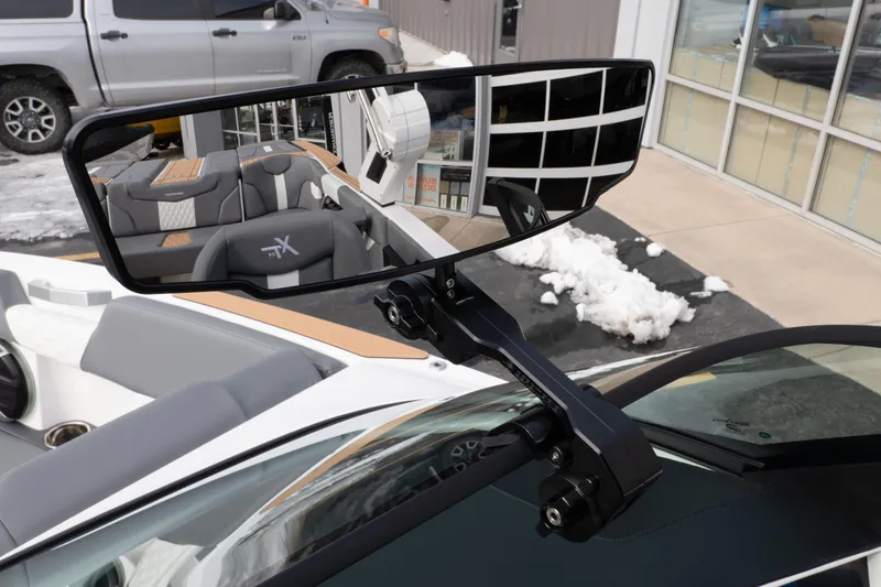 Slide: The Image of 2026 MasterCraft XT24 boat interior with rearview mirror and seating reflection. - 11
