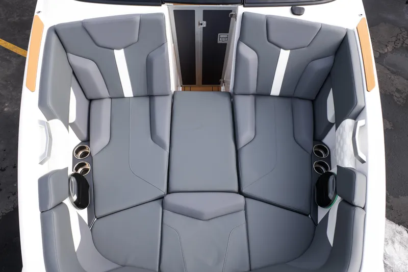 Slide: The Image of 2026 MasterCraft XT24 boat interior with gray seating and cup holders. - 16