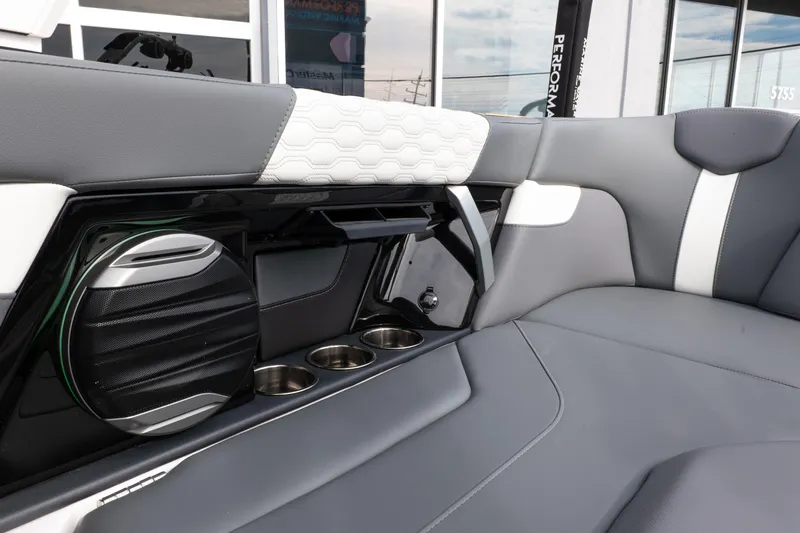 Slide: The Image of 2026 MasterCraft XT24 interior with sleek seating, speaker, and cup holders. - 29