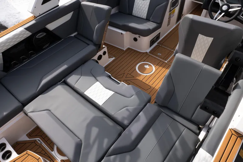 Slide: The Image of 2026 MasterCraft XT24 boat interior with luxurious seating and wood-style flooring. - 33