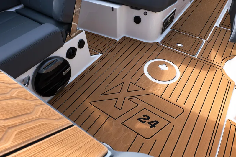 Slide: The Image of 2026 MasterCraft XT24 boat interior with sleek wood finish and modern seating. - 34