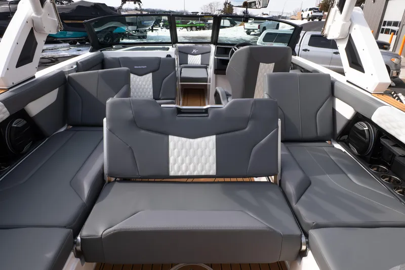 Slide: The Image of 2026 MasterCraft XT24 boat interior with luxurious gray seating and modern design. - 36
