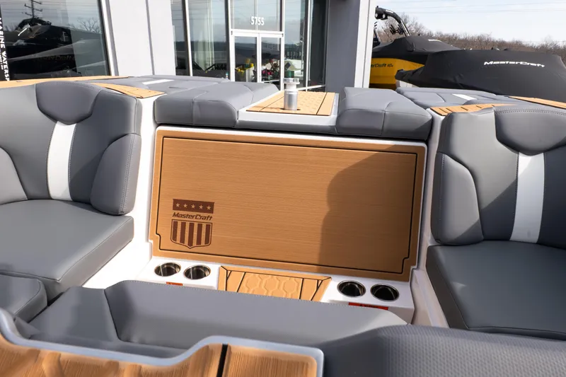 Slide: The Image of 2026 MasterCraft XT24 boat interior with gray seating and wood accents. - 37