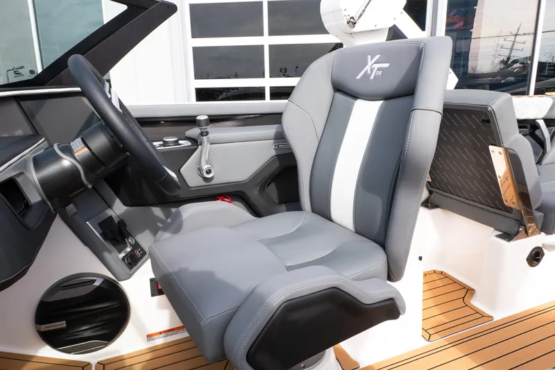 Slide: The Image of 2026 MasterCraft XT24 boat interior with sleek gray captain's seat and modern dashboard. - 43