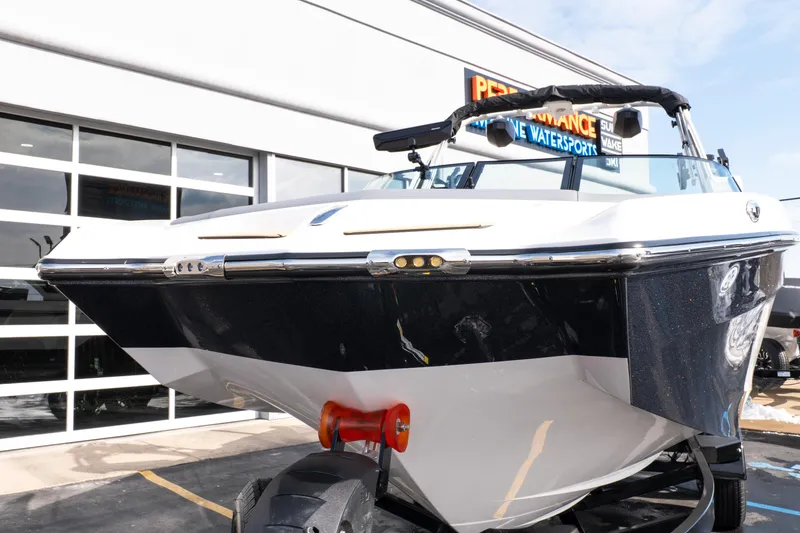 Slide: The Image of 2026 MasterCraft XT24 boat displayed outside a showroom. - 55