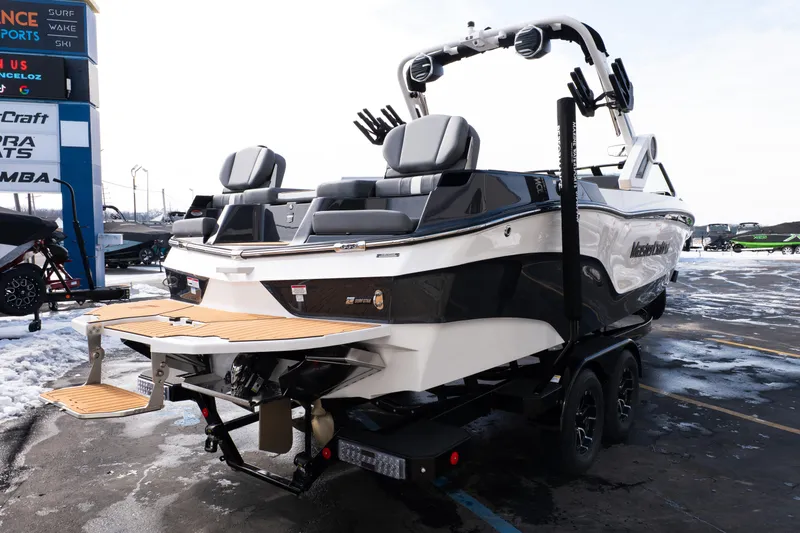 Slide: The Image of 2026 MasterCraft XT24 boat on trailer in snowy parking lot. - 69